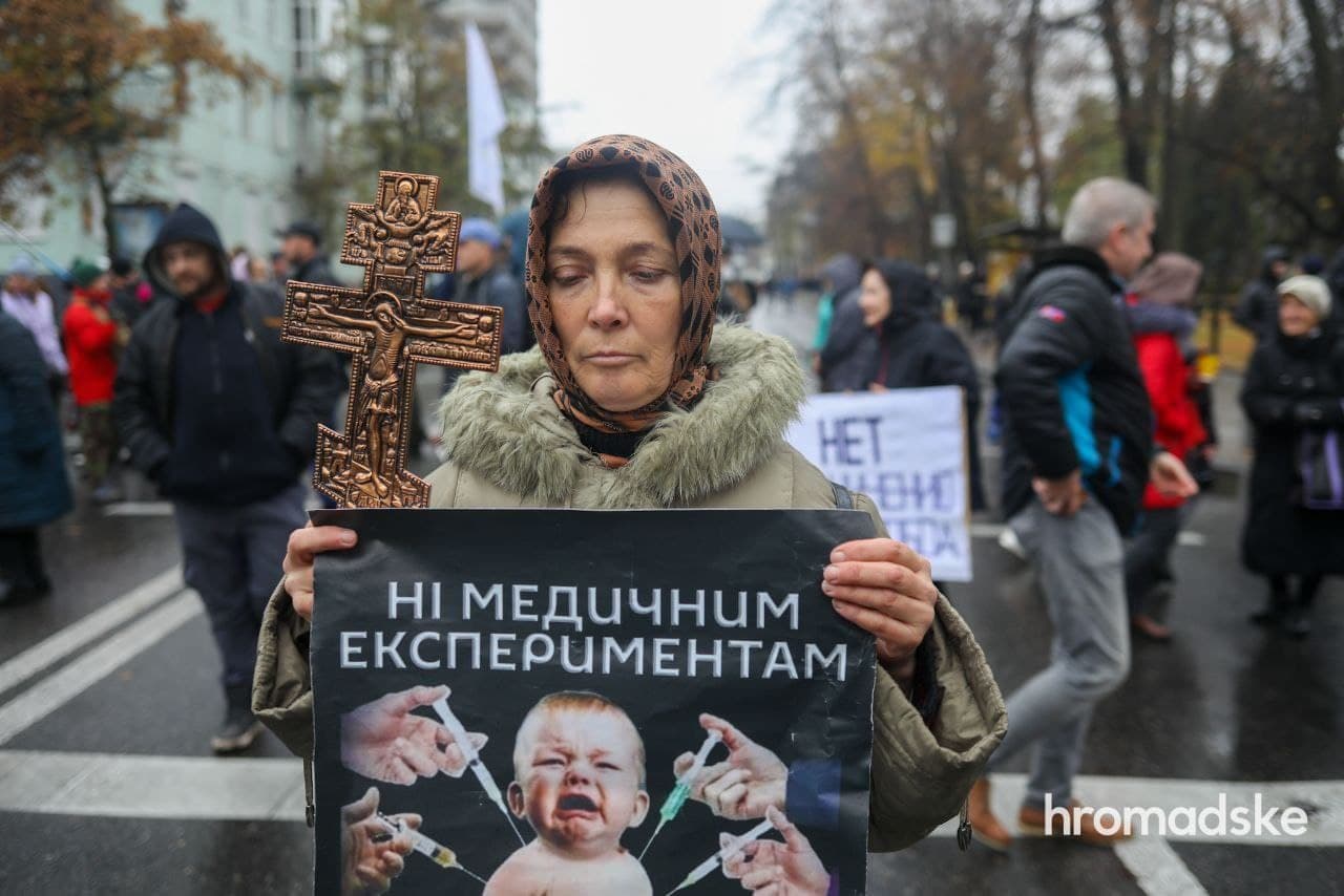 Протест антивакцинаторов в Киеве 3 ноября 2021 года. Женщина держит плакат, согласно которому, вакцинация детей понимается как медицинский эксперимент Протест антивакцинаторов в Киеве 3 ноября 2021 года. Женщина держит плакат, согласно которому, вакцинация детей понимается как медицинский эксперимент