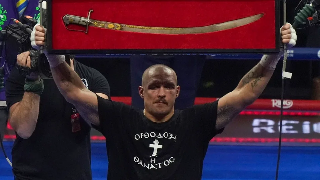 Усик тримає шаблю Мазепи після перемоги над Ф'юрі Олександр Усик тримає шаблю XVII століття, святкуючи перемогу в бою за титул чемпіона світу за версіями WBA, WBO та WBC проти британця Тайсона Ф’юрі в Ер-Ріяді, Саудівська Аравія, 22 грудня 2024 року