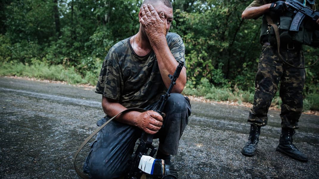 Український військовий на КПВВ патрулює дорогу в напрямку окупованої бойовиками Горлівки у Донецькій області, 28 серпня 2014 року