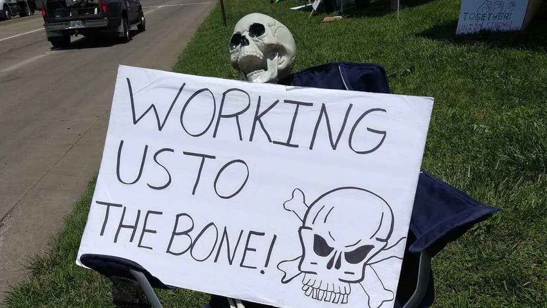 Страйк працівників заводу Frito-Lay в місті Топека американського штату Канзас, 16 липня 2021 року. На плакаті англійською написано «Доводите роботою до межі! (приблизний переклад)