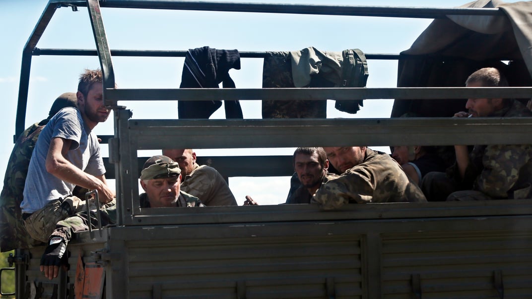 Украинские военные, которые смогли выйти из Иловайского котла, сидят в грузовике вблизи села Старобешево, 30 августа 2014 года