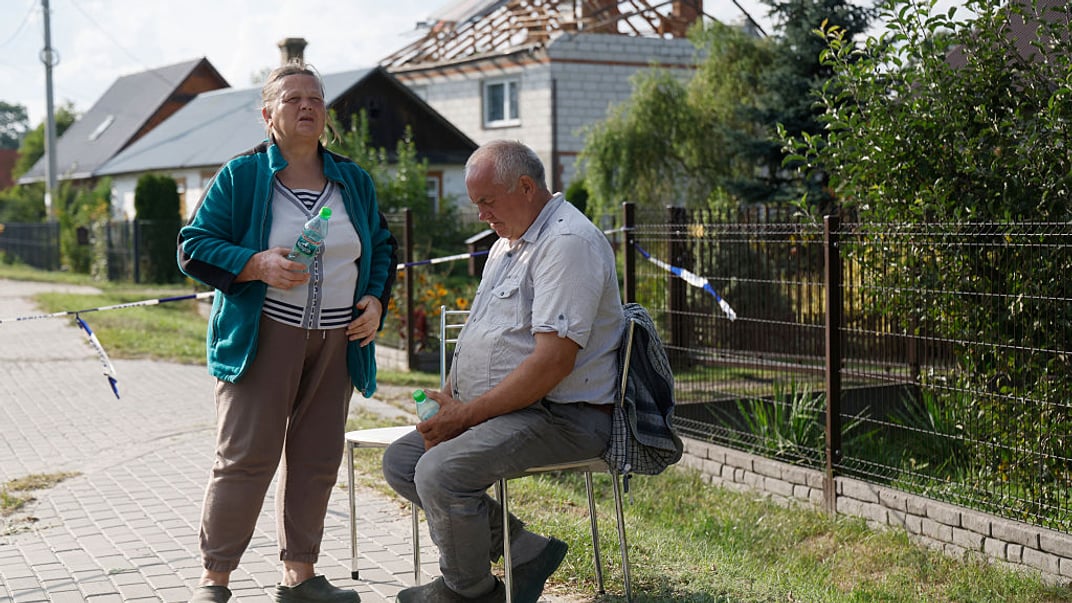 Аліція та Томаш Весоловські на тлі свого будинку, який зазнав пошкоджень внаслідок падіння російського дрона у селі Вирки-Воля, 10 вересня 2025 року