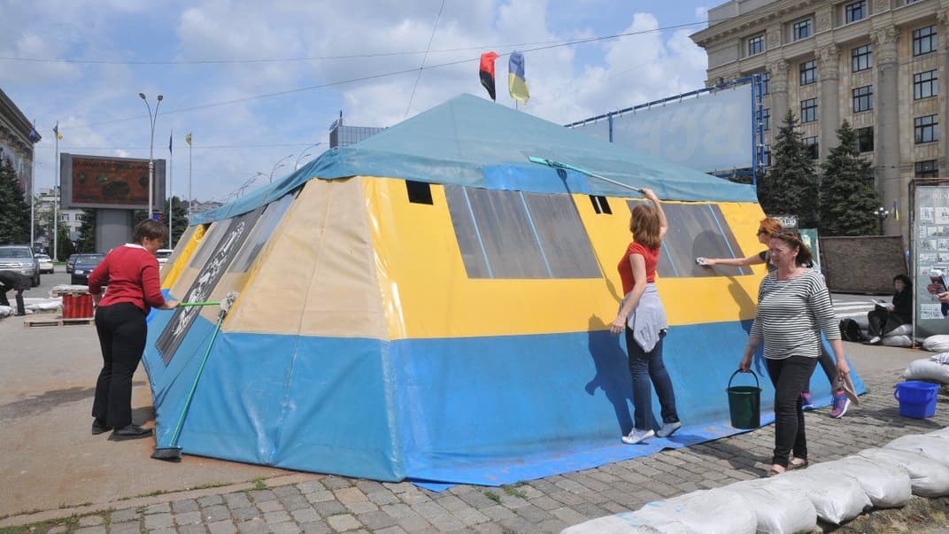Волонтерки миють волонтерський намет на площі Свободи в Харкові, який намагались знести комунальники за ініціативи мера Кернеса, 13 травня 2019 року