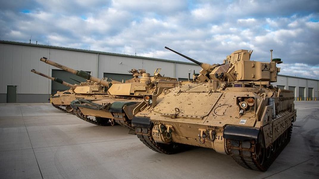 Бойова машина піхоти Bradley й танки M1 Abrams під час відкриття нового логістично-технічного комплексу в Польщі, 5 квітня 2023 року