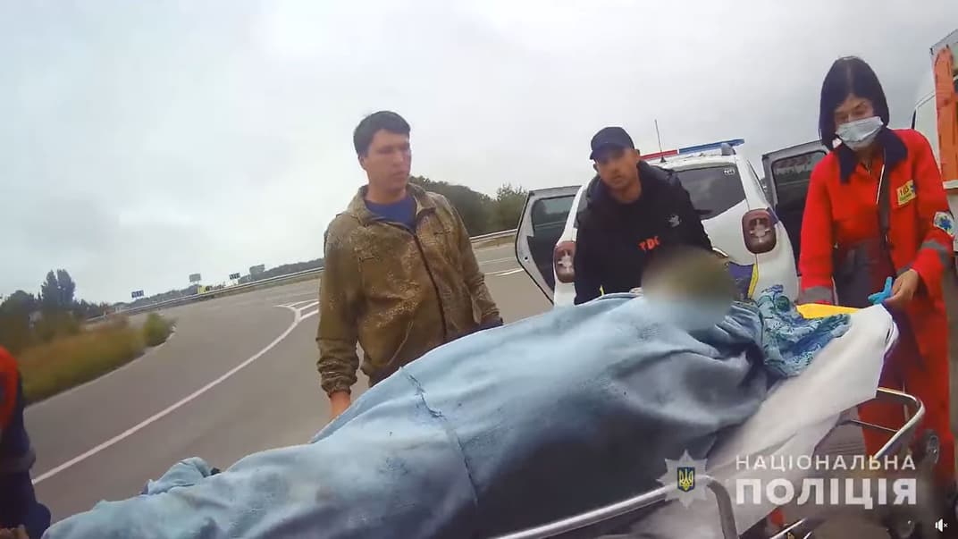 Спасенную пожилую женщину везут в машину «скорой»