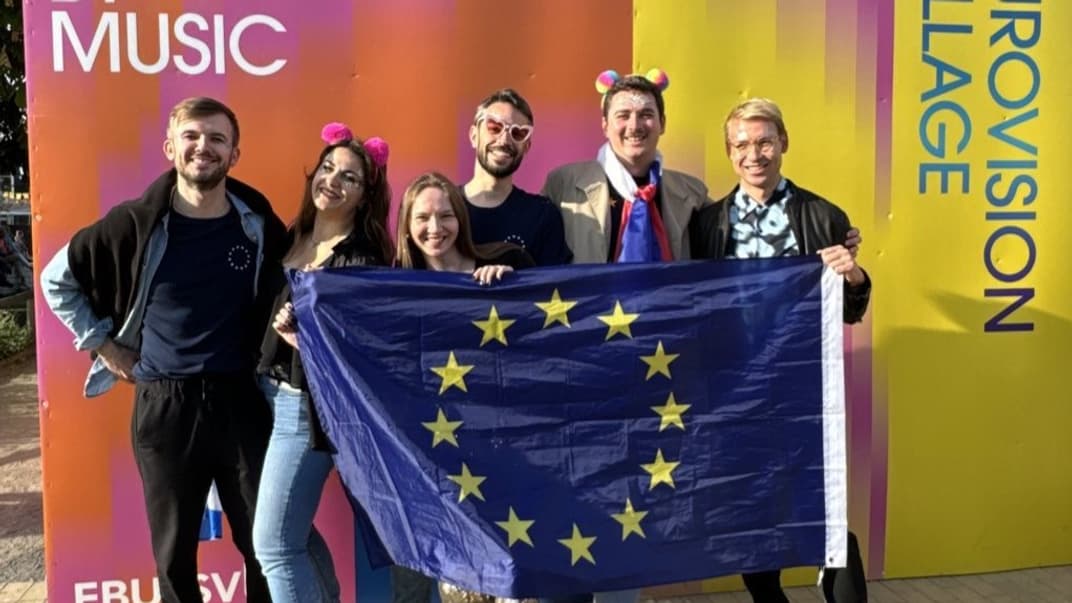 Политик Дорин Фрасиняну (крайний слева) смог развернуть привезенный флаг ЕС на несколько минут, прежде чем охрана попросила его убрать символику