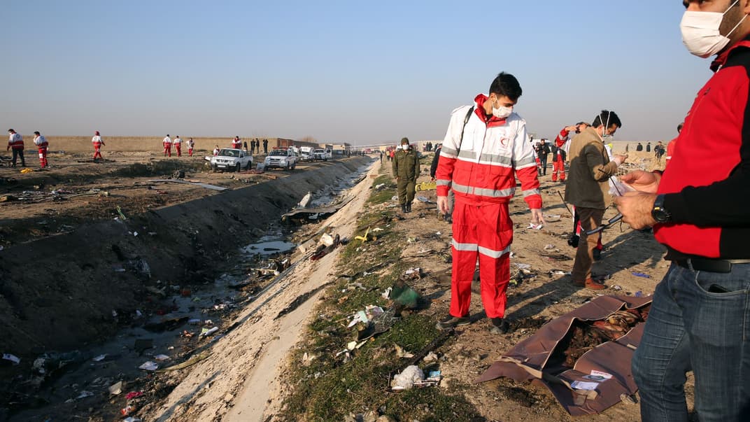 Волонтери Червоного Хреста на місці падіння літака української авіакомпанії МАУ неподалік аеропорту «Імам Хомейні» в Тегерані, Іран, 8 січня 2020 року. Літак Boeing-737 розбився майже одразу після зльоту вранці 8 січня. На борту перебували 167 пасажирів та 9 членів екіпажу, усі вони загинули