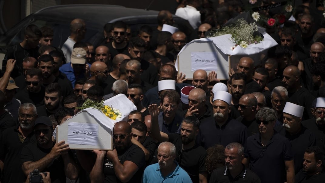 Представители друзского меньшинства несут гробы некоторых из 12 детей и подростков, погибших во время ракетного обстрела футбольного поля у села Мадждал-Шамс на аннексированных Израилем Голанских высотах, 28 июля 2024 года