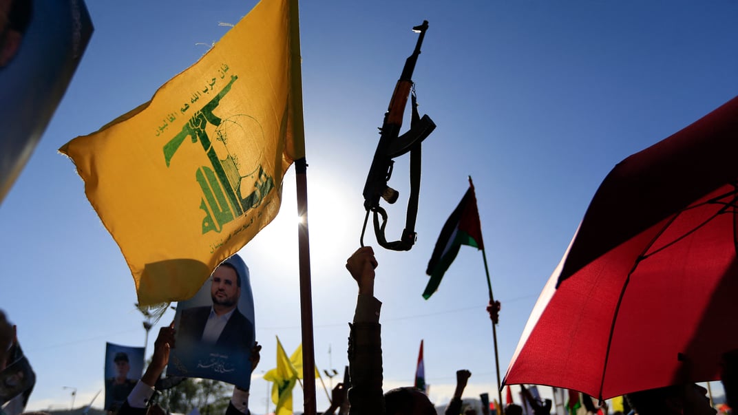 Ілюстративне фото. Єменці підіймають прапор ліванської «Хезболли» та гвинтівку під час мітингу, Сані, 4 жовтня 2024 року