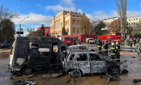 Rescue workers survey the scene of a Russian attack on Kyiv, Ukraine on Oct. 10, 2022