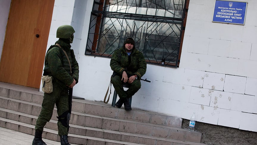 Russia's "green men," i.e. the soldiers with no identifying insignia that were only claimed by Russia in the aftermath of the annexation, block a military unit in Simferopol, Crimea, Ukraine on March 18, 2014.