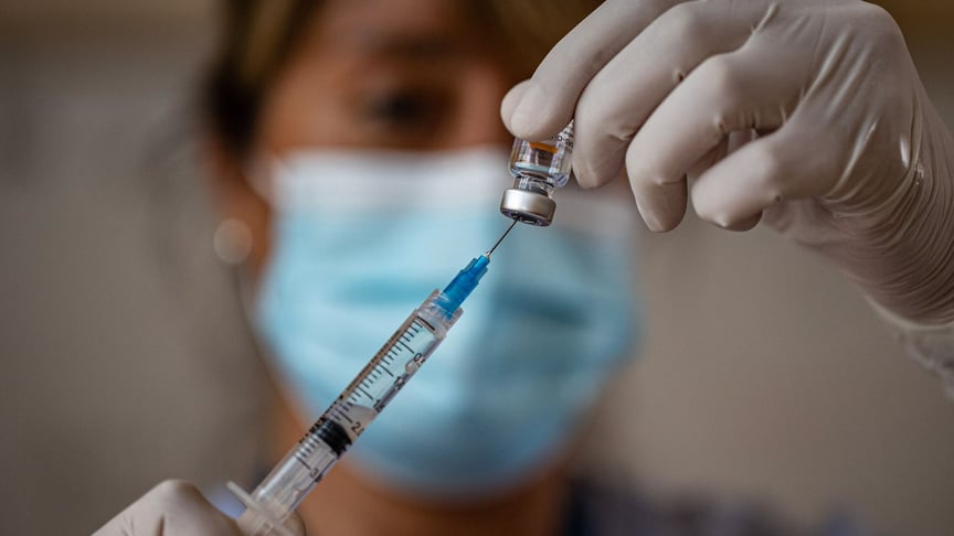 Медицинская работница готовит укол вакцины CoronaVac против COVID-19, производимой китайской компанией Sinovac Biotech, в государственной школе Сальвадора Санфуентеса во время начала общегосударственных прививок для педагогов в Сантьяго, Чили, 15 февраля 2021 года