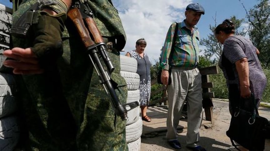 Ukrainian President Volodymyr Zelenskyy said that elections in Donbas will only be possible after the withdrawal of troops from occupied territories. (Pictured- people crossing a bridge in Stanytsia Luhanska, on the Russian-backed separatist-controlled side)