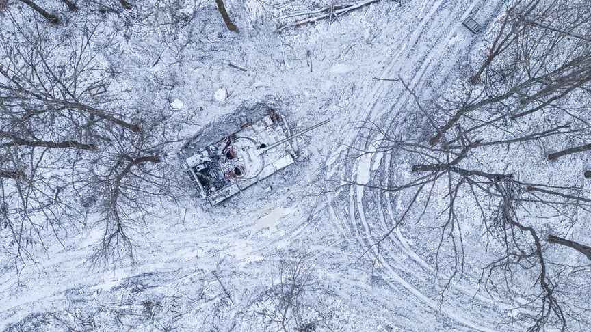A destroyed Russian tank covered with snow stands in a forest in Kharkiv Oblast, January 14, 2023.