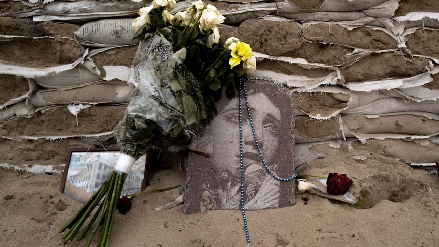 An icon and flowers lie on sandbags covering the historical monument to Princess Olga in Kyiv, January 6, 2023