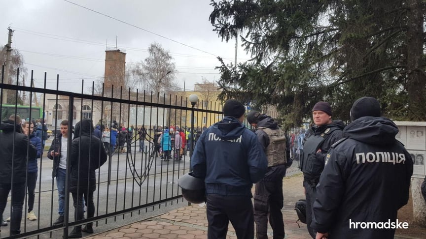 Police officers gather near the police precinct in the town of Kakhovka in the Kherson region, where a protest took place on January 5.