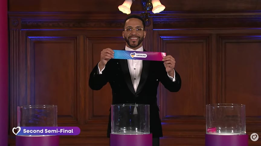 Ведучий Сезар Сампсон тримає аркуш з написом «Ukraine» під час жеребкування на «Євробачення-2026»