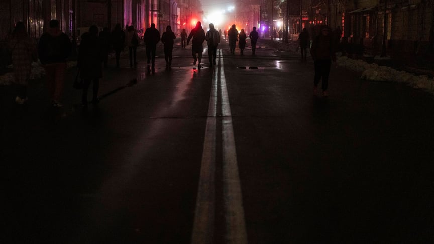 People walk in the center of Kyiv, where electricity was cut off after a Russian missile attack the day before, November 24, 2022