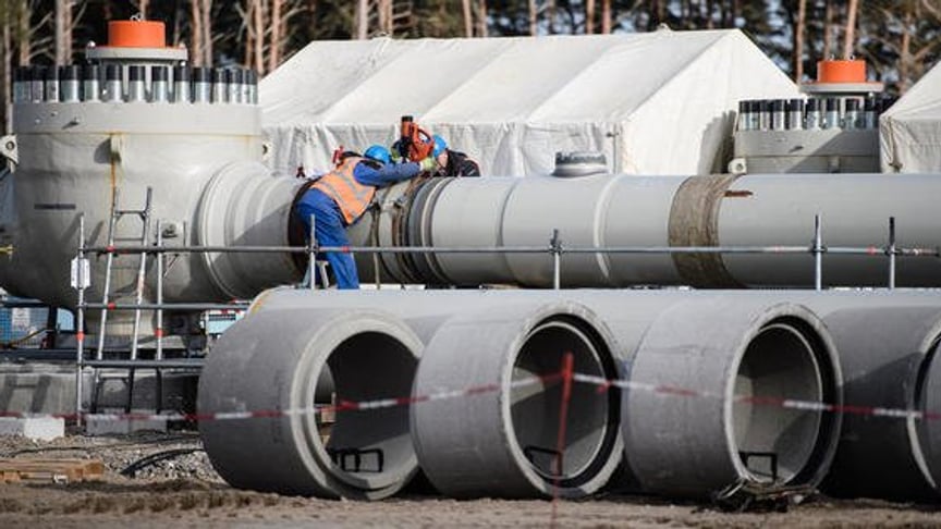 Workers work on a pipeline tube on the construction site of the Nord Stream 2 pipeline in Lubmin, Germany, 26 March 2019 (reissued 12 December 2019).