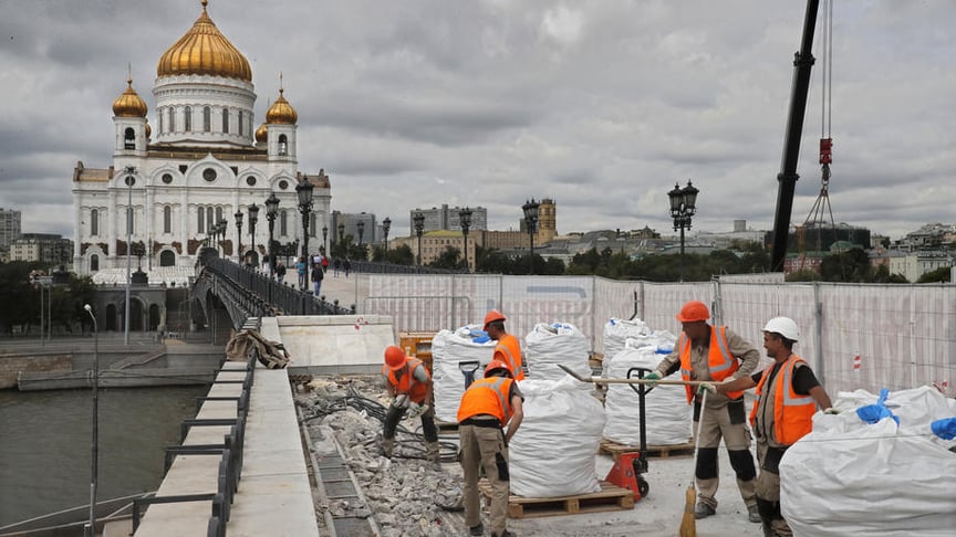 Builders work on the reconstruction of the Patriarchal Bridge in front of Christ the Savior Cathedral in central Moscow, Russia on July 10, 2019.