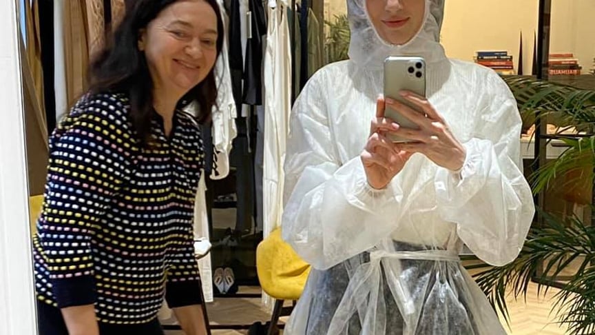 Designer fashion Svitlana Bevza, right, in a protective suit in her studio.