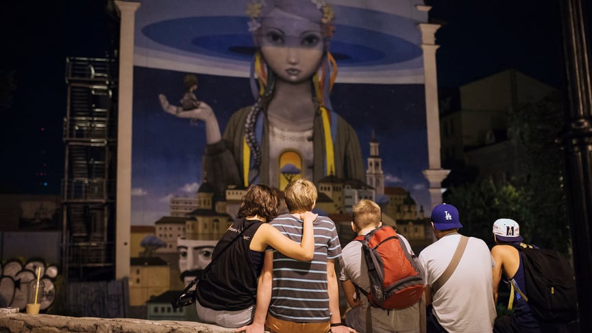 People sit on the Andriyivskyi Descent in Kyiv, Ukraine on July 26, 2015.