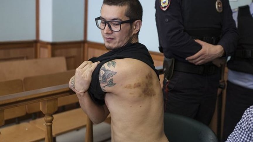 Russian Journalist Describes Brutal Beating After Deportation Trial