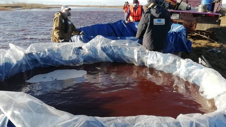 Рятувальники Морської рятувальної служби Росії збирають дизельне паливо, яке вилилося в річку Амбарна поблизу Норильська, Росія