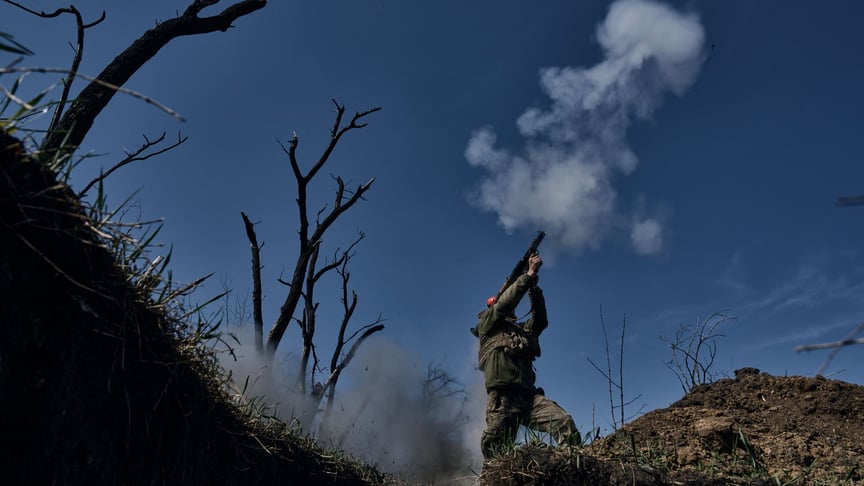 A Ukrainian soldier fires a grenade launcher at the front line in Bakhmut, April 10, 2023