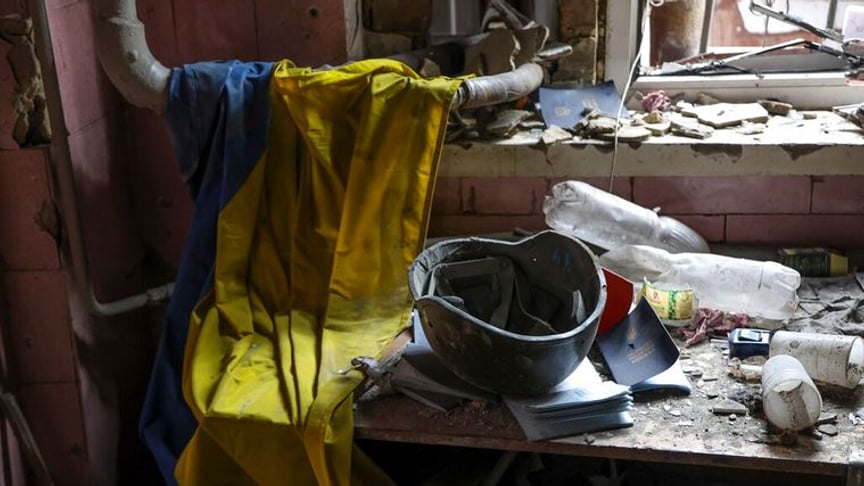 Ukrainian flag, helmet and medical documents in a ruined building in Mariupol, April 18, 2022