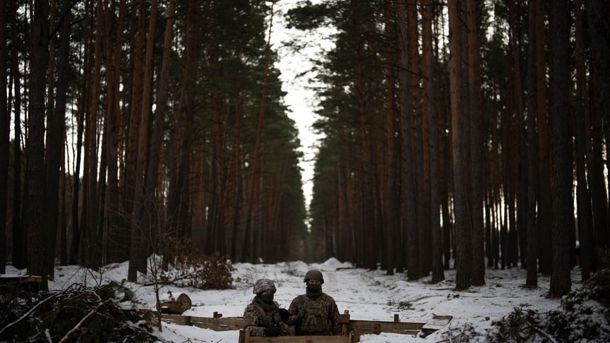 Ukrainian soldiers stand in position near the border with Belarus, February 1, 2023