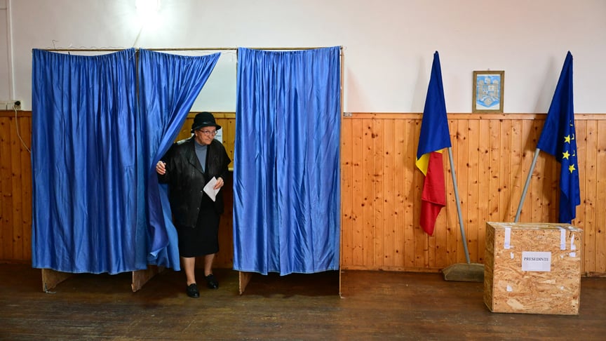 Жінка виходить з кабінки, щоб проголосувати на виборчій дільниці в Першані під час другого туру президентських виборів у Румунії, 18 травня 2025 року