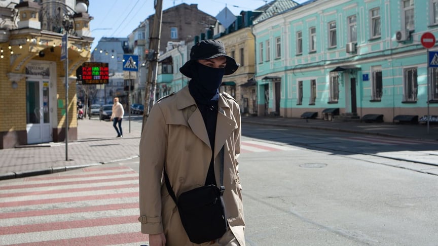 A man wearing a mask walks on Kontraktova Square in Kyiv, Ukraine. March 20, 2020.