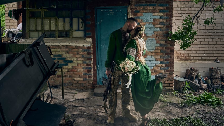 Military volunteer medics with call signs Mykyta and Polka kiss during a wedding ceremony at the front line in Donetsk region, June 29, 2023